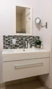 a bathroom with a white sink and a mirror at 18 on Tides End in Knysna
