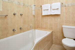 a bathroom with a white tub and a toilet at First Group Port Owen Marina in Velddrif