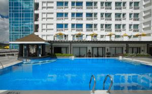 a large swimming pool in a large building at Quest Hotel & Conference Center Cebu in Cebu City