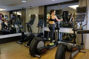 a woman standing on a treadmill in a gym at Quest Hotel & Conference Center Cebu in Cebu City