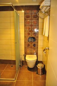 a small bathroom with a toilet and a shower at Aura Boutique Hotel in Side