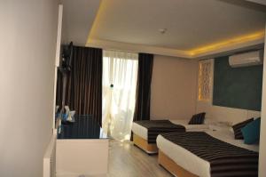 Postel nebo postele na pokoji v ubytování Aura Boutique Hotel