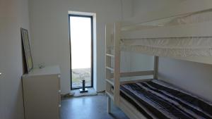 a bedroom with two bunk beds and a window at Almbacka Logi lgh 2 in Skivarp