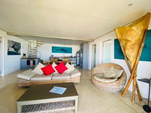 a living room with a couch and a chair at Waterside Apartment in Gansbaai