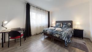 a bedroom with a bed and a desk and a desk at Les Charpentiers in Colmar