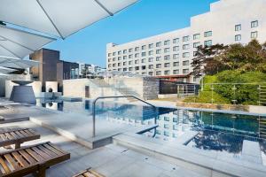 a swimming pool on the roof of a building at Maison Glad Jeju in Jeju