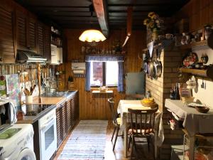 a kitchen with a table and a dining room at Na chalúpke in Liptovský Mikuláš
