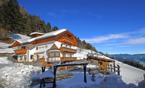 a building on top of a snow covered mountain at Felderhof in Maranza