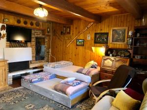 a room with four beds and a television in it at Na chalúpke in Liptovský Mikuláš