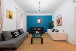 a living room with a couch and a table at Apartamentos Day Madrid GRAN VIA Centro Sol Malasaña in Madrid