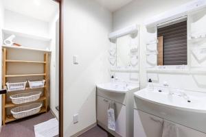 a white bathroom with a sink and a mirror at THE EAST AVENUE in Sapporo +44 photos