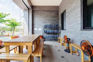 a dining room with wooden tables and blue chairs at 98Inn in Xiaoliuqiu