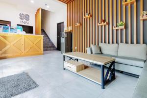 a living room with a couch and a table at 98Inn in Xiaoliuqiu