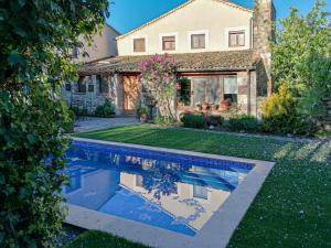 a house with a swimming pool in front of a house at Charming Boutique Country House: La Casa Vieja (Sotosalbos) in Sotosalbos