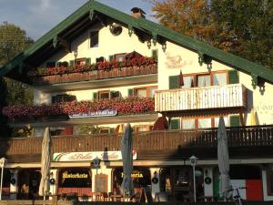 a building with a balcony with flowers on it at Hotel Bavaria in Bad Wiessee