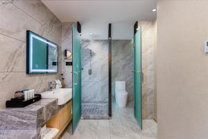 a bathroom with a shower and a sink and a toilet at Lan Hotel (Kuanzhai Alley) in Chengdu