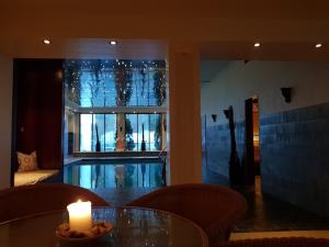 a candle on a table in a room with a window at Sanner Hotell in Gran