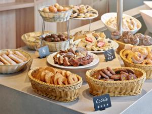a buffet of different types of pastries on a table at Maistra Select Family Hotel Amarin in Rovinj