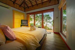 a bedroom with a large bed and a large window at Siam Bay Resort in Ko Chang