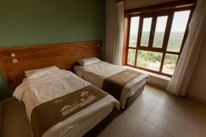 two beds in a room with a window at Ajloun Forest Reserve in Jerash