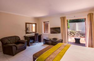 a hotel room with a bed and a chair and a window at Sandton Times Square in Johannesburg