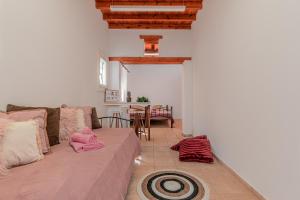 a living room with a couch and a table at Dimelal Mykonos Town Apartments in Mýkonos City