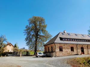 a brick building with a car parked in front of it at Resort Český ráj in Troskovice