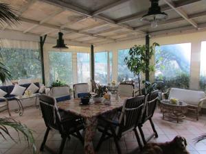 a dining room with a table and chairs and a dog at B&B Palazzo a Mare in Capri