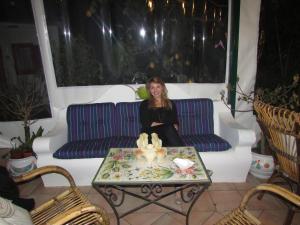a woman sitting on a couch in a living room at B&B Palazzo a Mare in Capri