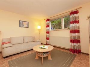 a living room with a couch and a table at Cosy apartment in Neustra burg in Balesfeld