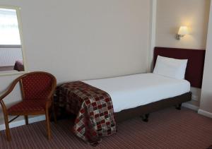 A bed or beds in a room at King Charles Hotel 