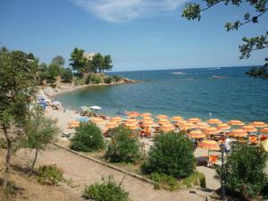 a beach with many umbrellas and people on it at Casa Turusele in Santa Maria Navarrese