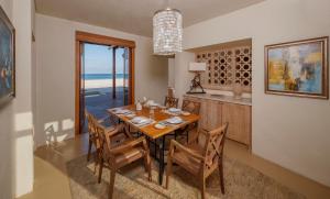 a dining room with a table and chairs and the ocean at Anantara Sir Bani Yas Island Al Yamm Villa Resort in Da‘sah