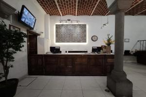 a large room with a reception desk in a building at Hotel Del Portal, Puebla in Puebla