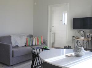 a living room with a couch and a table at Tofta Resort in Tofta