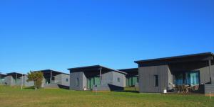 a row of modular homes in a field at Tofta Resort in Tofta