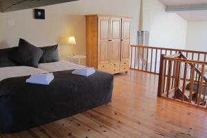 a bedroom with a bed and a wooden floor at Domaine de la Bade in Raissac-sur-Lampy +113 photos