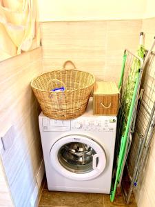a washing machine with a basket on top of it at Agriturismo Il Colle in Poggio Alla Croce