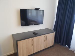 a television mounted on a wall in a room at Premium Crown Suites in Belgrade