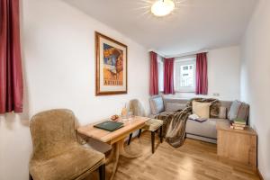 a living room with a table and a couch at Hotel Goethehof in Bad Gastein