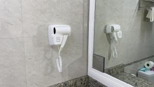 a bathroom with two phones on the wall at Bay Gardens Inn in Gros Islet