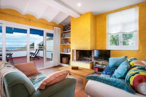 a living room with a couch and a fireplace at Casa Malva Sa Tuna in Begur