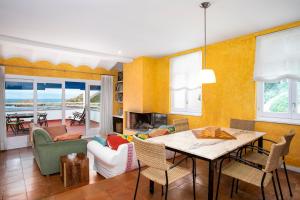 a living room with a table and a couch at Casa Malva Sa Tuna in Begur