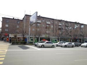 a parking lot with cars parked in front of a building at Your lovely stay in Yerevan, Komitas 30 in Yerevan