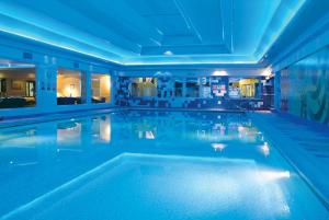 a swimming pool in a hotel with blue lighting at Dalmeny Hotel in Lytham St Annes