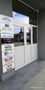 a garage with white doors and signs on the wall at WHITE CORAL CLUB in Košice