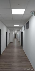 an empty hallway of an office building with white walls at WHITE CORAL CLUB in Košice