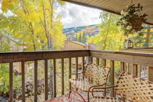 a balcony with two chairs and a view at Peaceful creek view from the deck! Walk to Shuttle in Vail