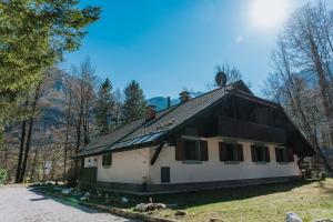 a house with a gambrel roof on top of it at TUBA Apartments in Bohinj