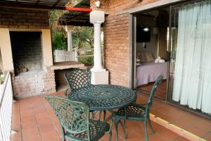 a table and chairs sitting on a patio at Ikaia River Lodge in Keimoes